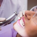 dentist examining female patient 107420 65401