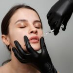 high angle woman getting lip fillers 23 2149341863